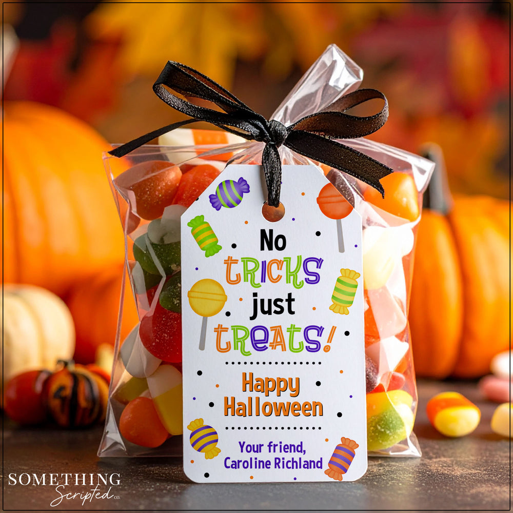 Bag of Halloween candy with a personalized tag in front of pumpkins